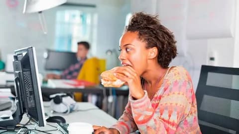A plate of jollof rice next to a laptop